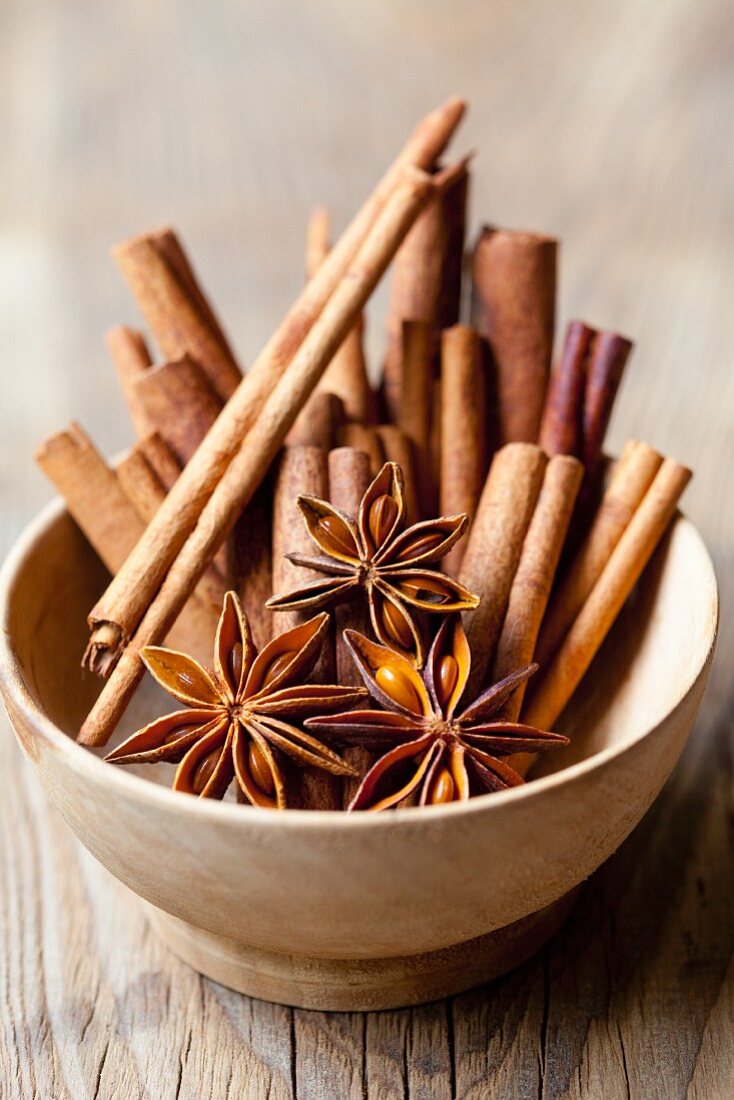 Cinnamon sticks and star anise in a wooden bowl