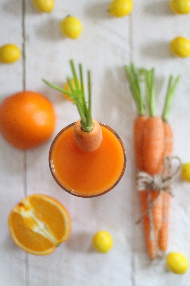Carrot juice, fresh carrots and citrus fruits
