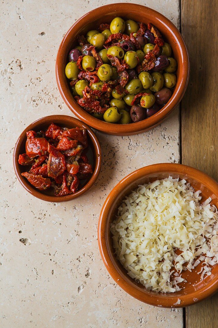 Mixed marinated olives with dried tomatoes and freshly grated Parmesan
