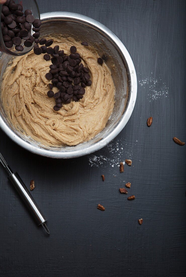 Chocolate Chip Cookie Dough in a Mixing Bowl with Wooden Spoon