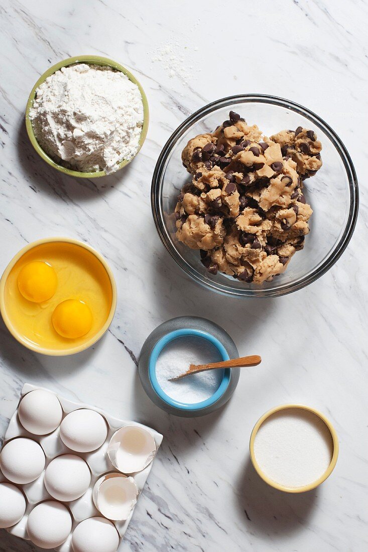 Chocolate chip cookies with baking ingredients (seen from above)