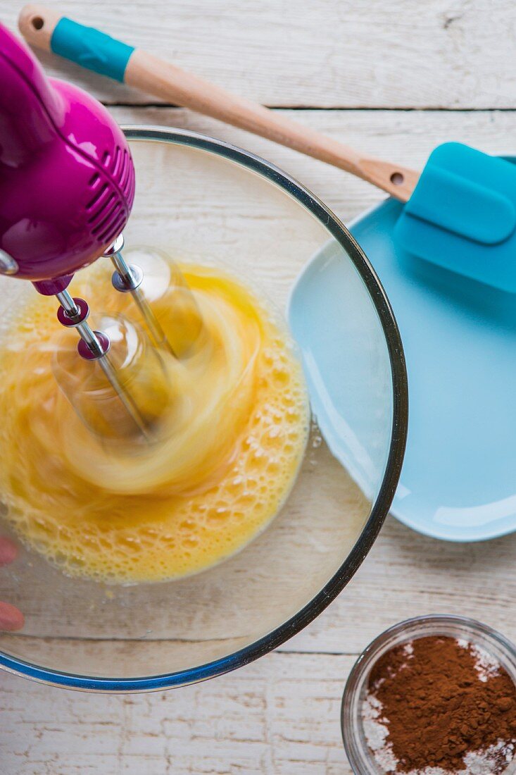 Eggs being beaten with an electric whisk (ingredients for fondant au chocolat)