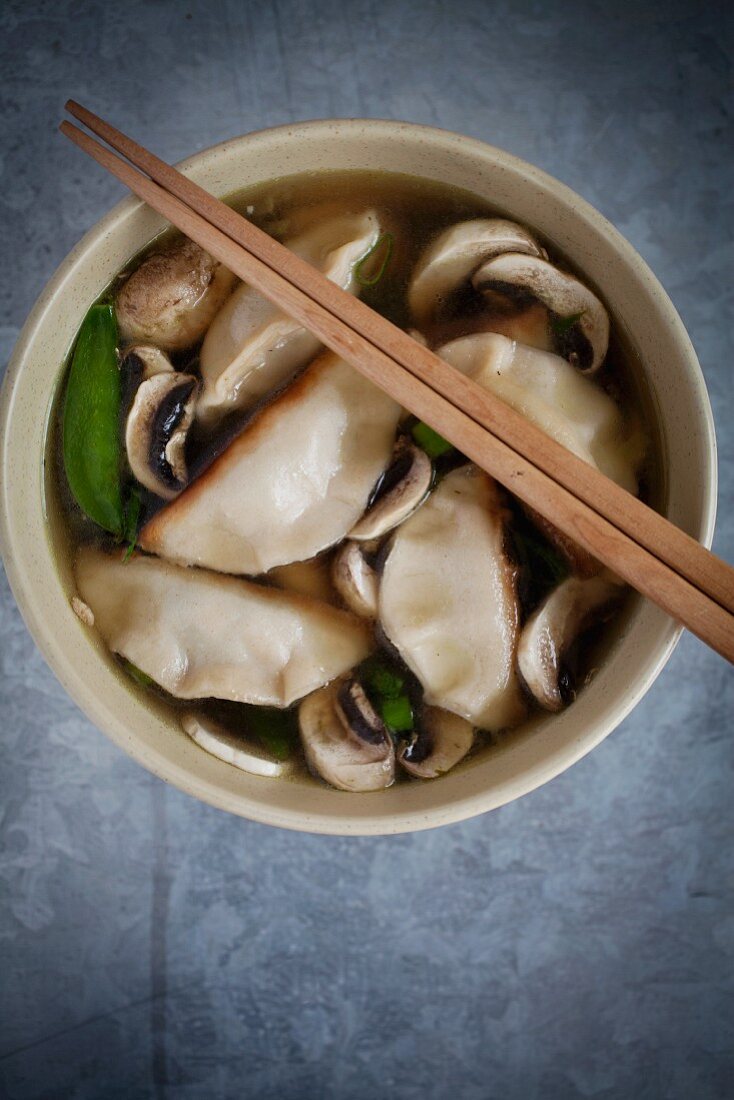Miso soup with ginger, mange tout, spring onions, mushrooms and gyoza (Japan)