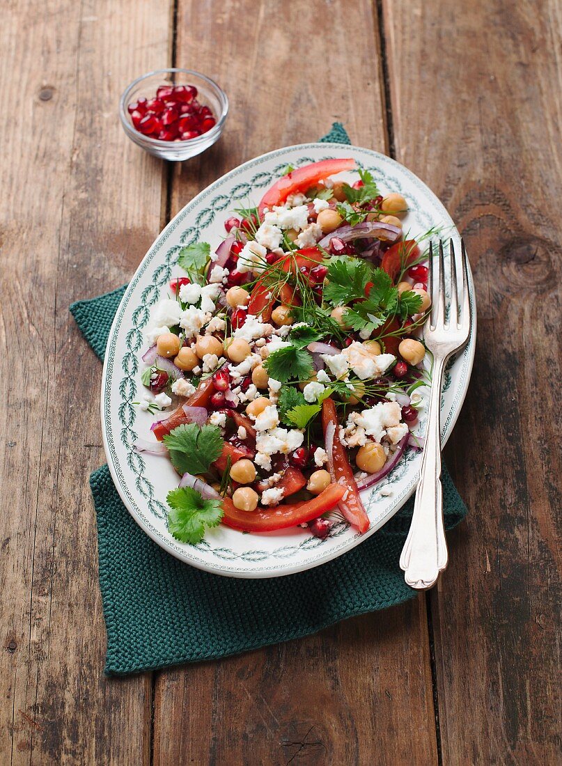 Chickpea salad with peppers, feta cheese and pomegranate seeds