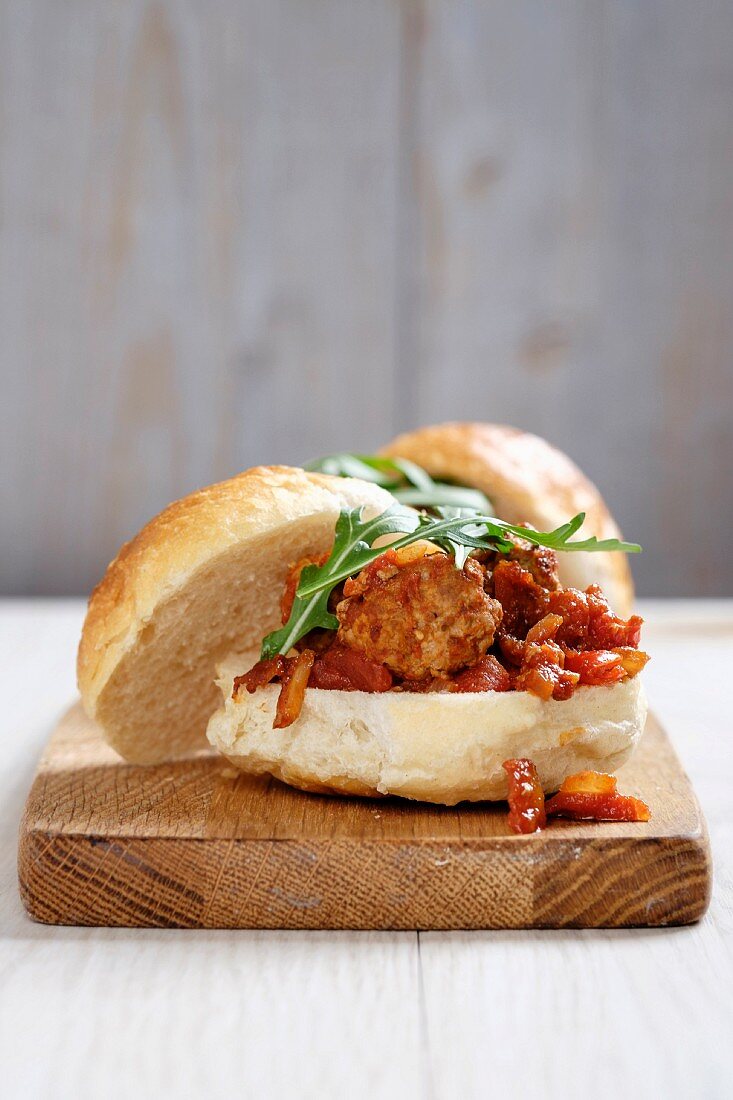 A turkey meatball sandwich with a tomato and onion sauce
