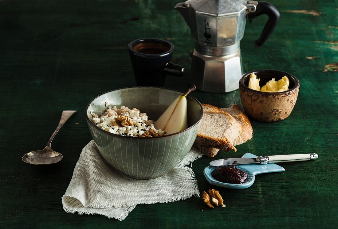 Muesli with pears and walnuts, bread, jam and coffee