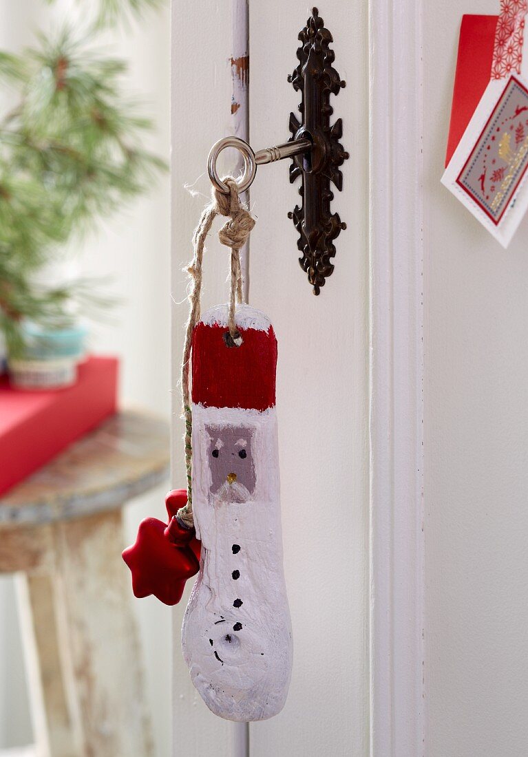 Homemade key rings made from painted driftwood with Christmas motifs