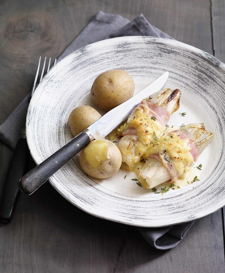 Gratinated chicory wrapped in ham with new potatoes