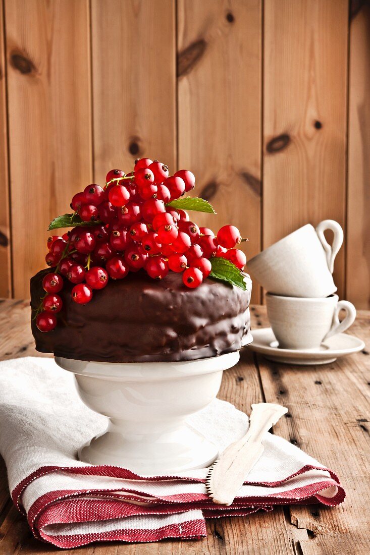 A mini chocolate cake with redcurrants