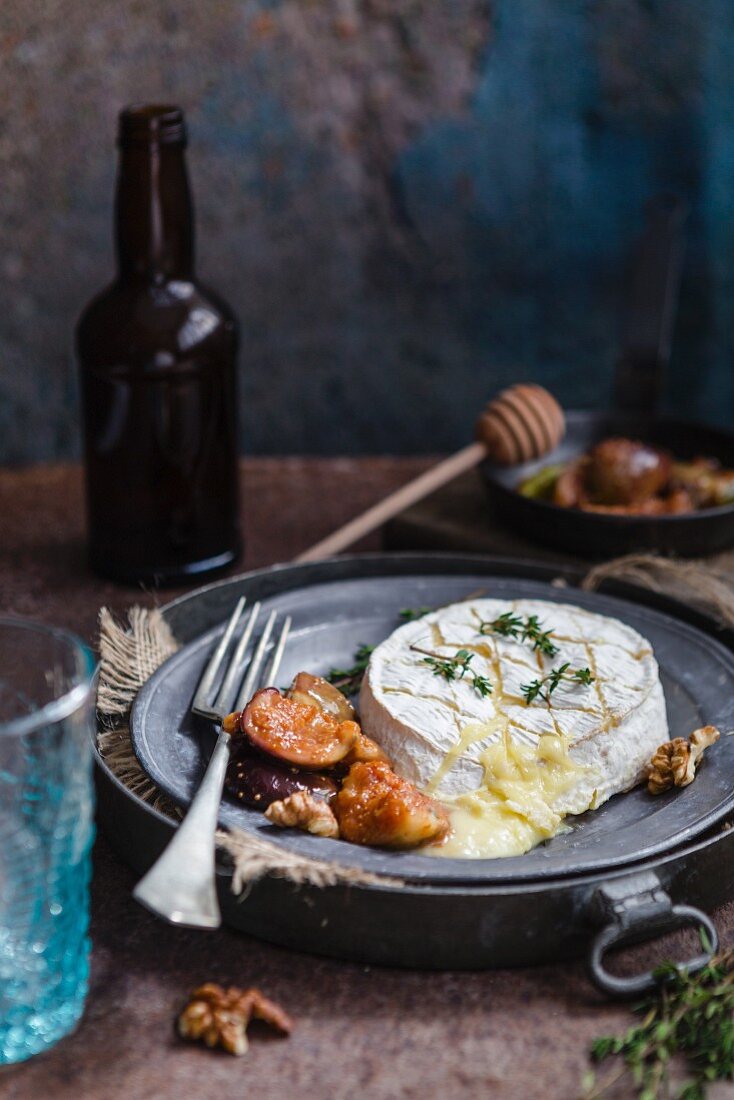 Baked Camembert with figs on a metal plate