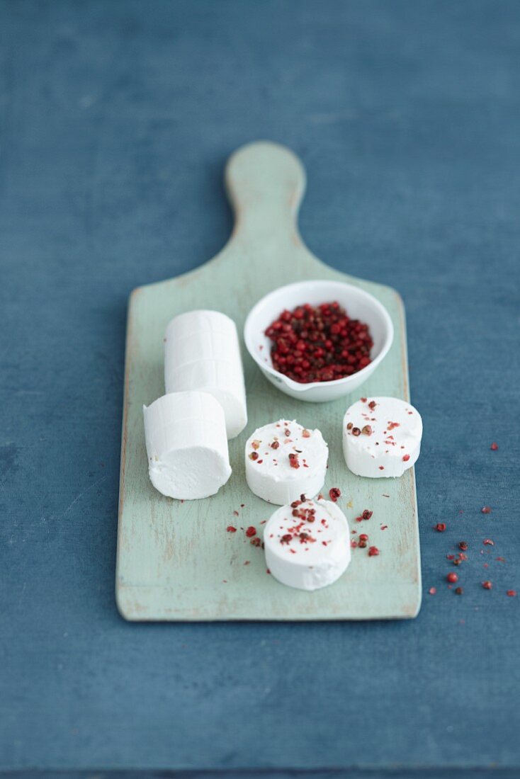 A roll of goat's cream cheese and pink pepper