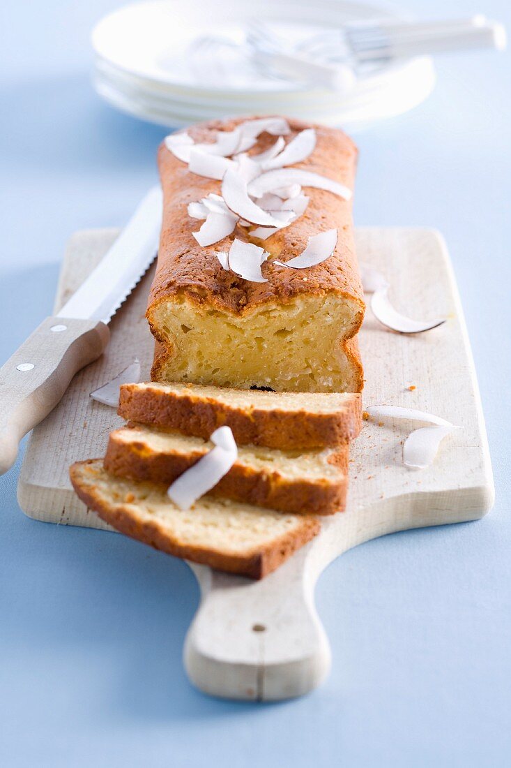 Partially Sliced Coconut Cake on a Cooling Rack