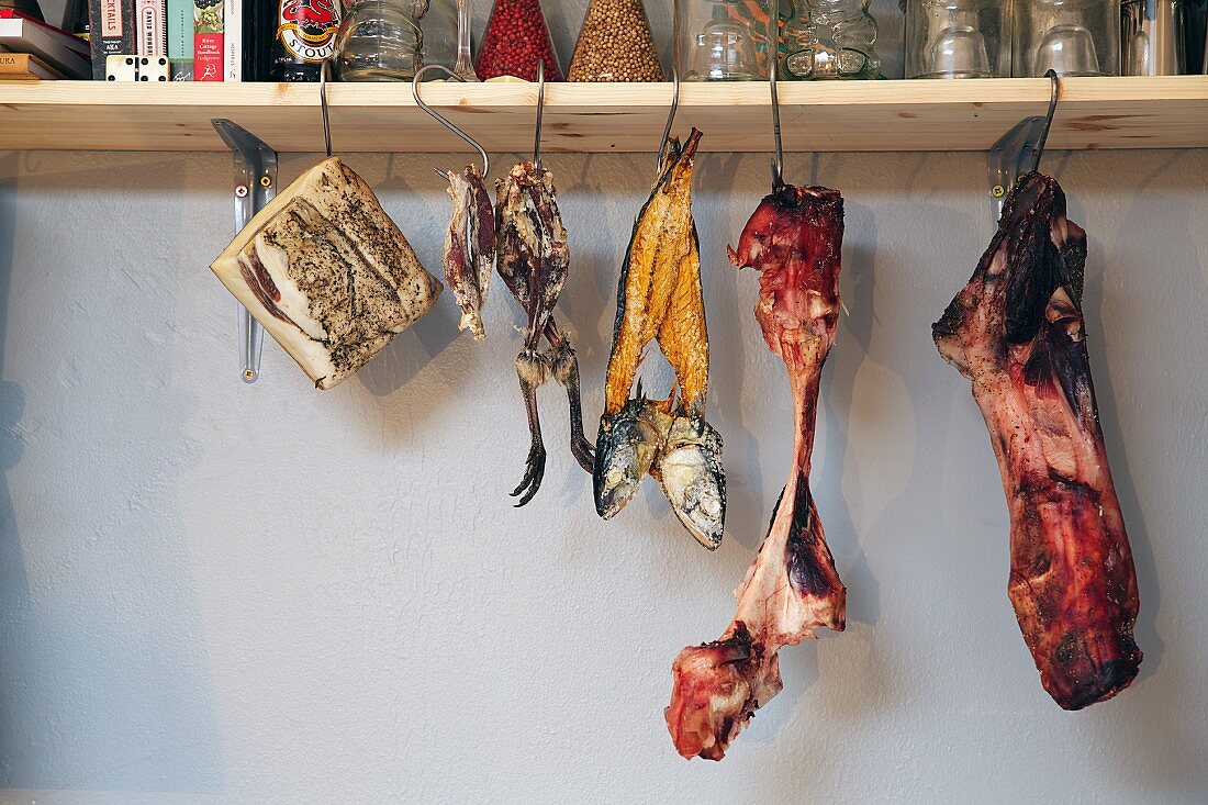 Smoked meat, fish and poultry on hooks