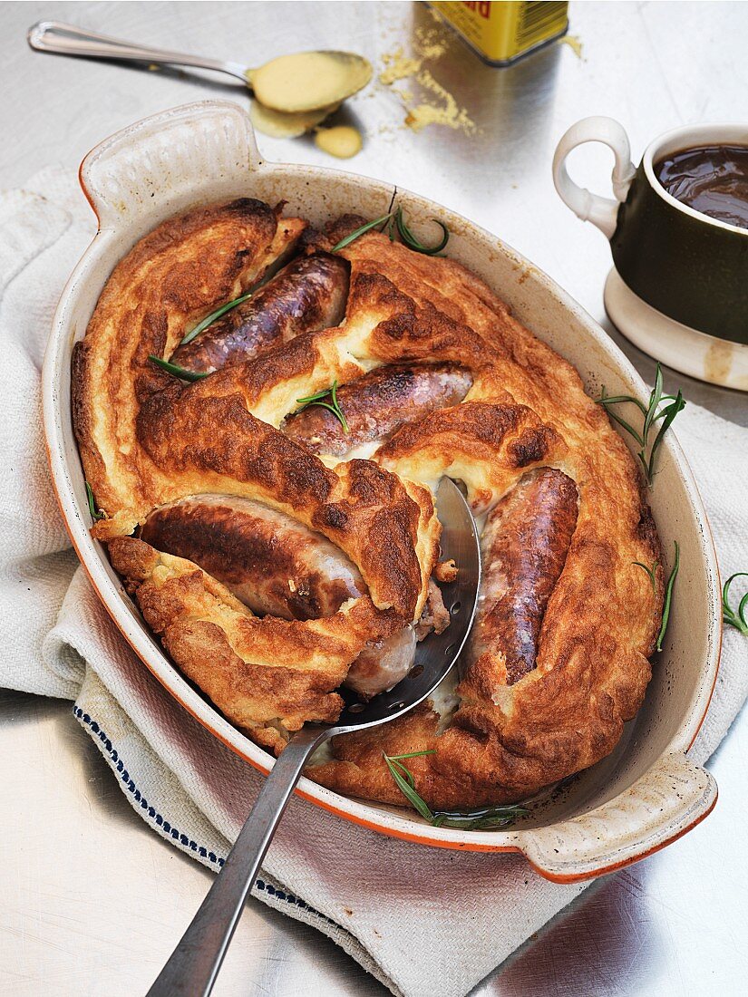 Toad in the hole with gravy and mustard (England)