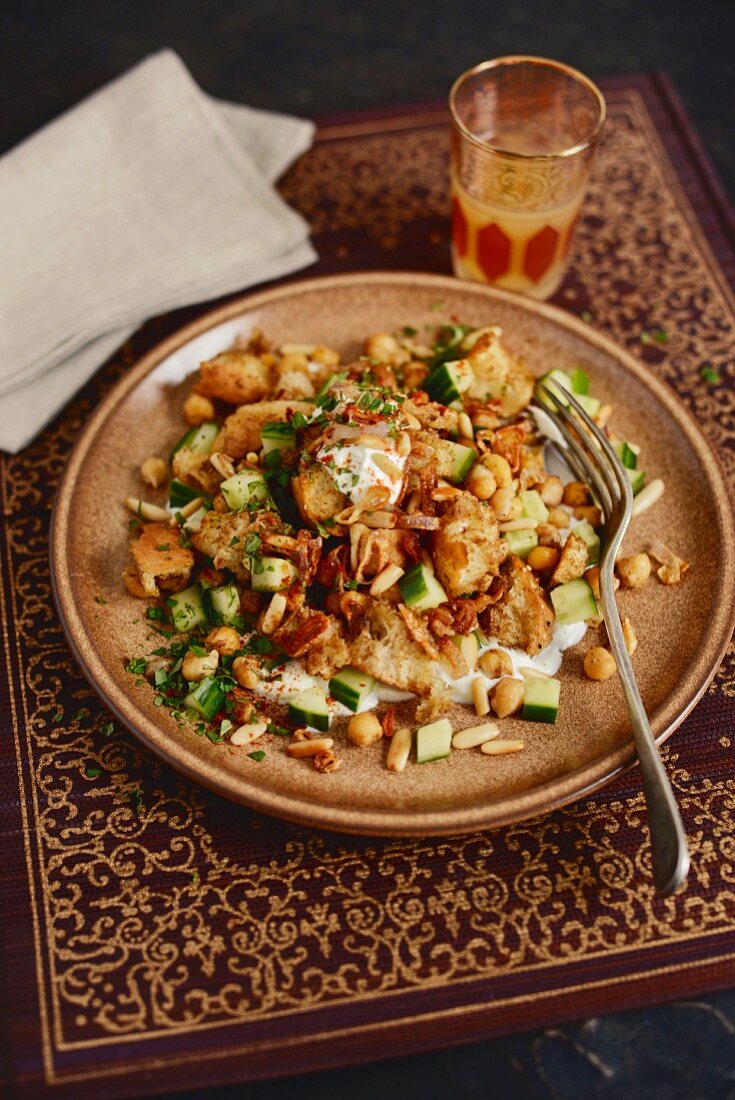 Bread salad with chickpeas, cucumber and pine nuts (Arabia)