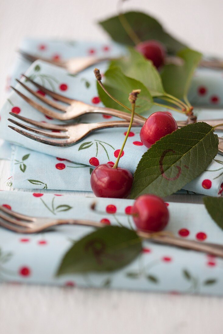 Cherries, napkins and cake forks