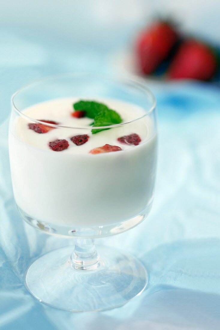 Kefir with strawberries and mint in a dessert glass
