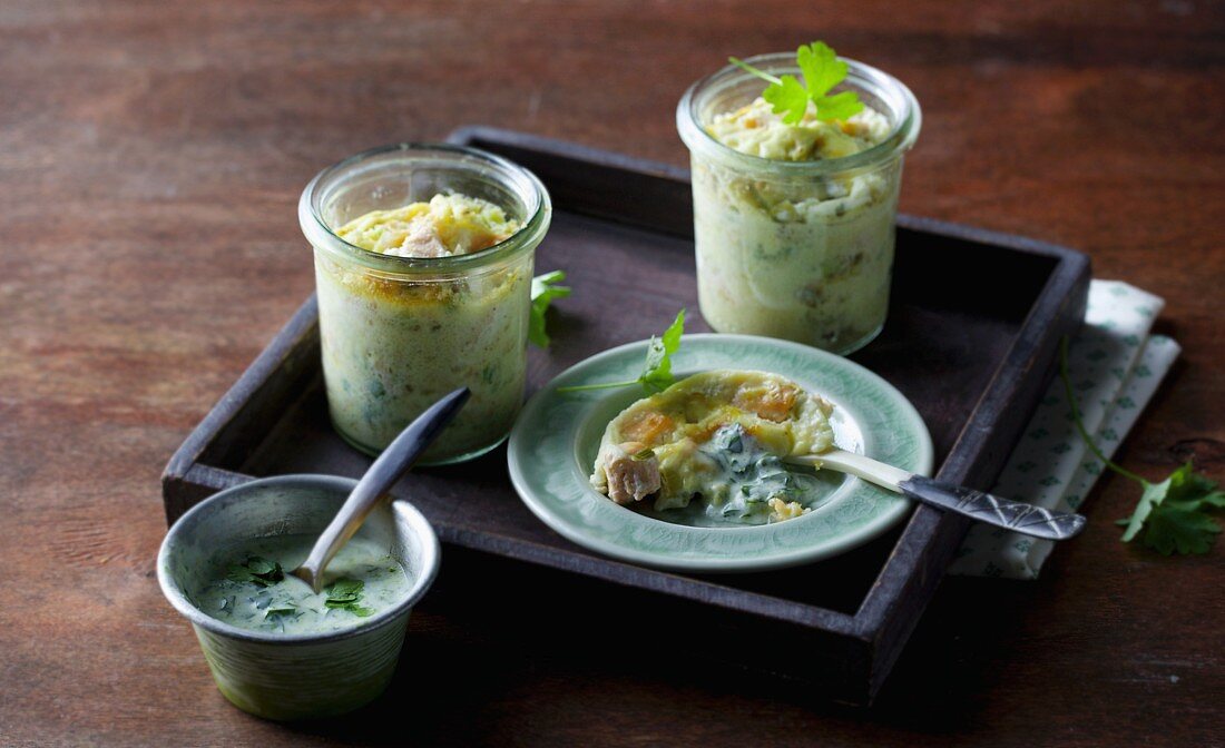 Salmon trout pie served in glasses with a green sauce