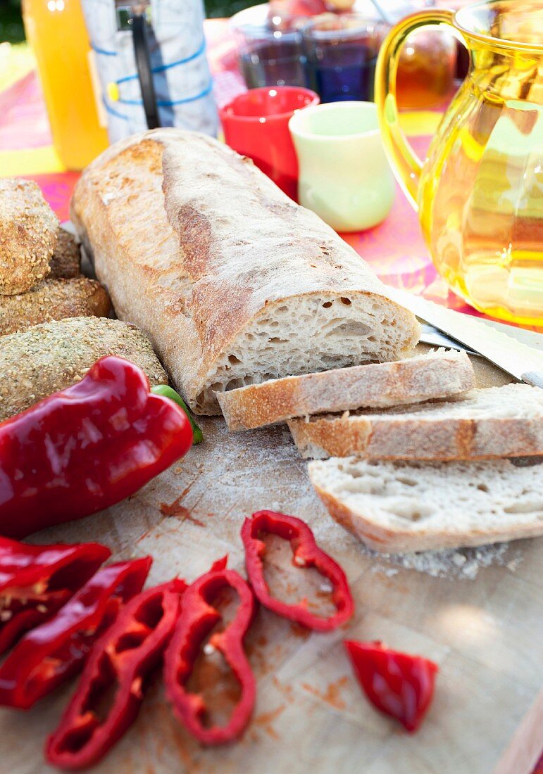 Sliced white bread and red pepper on table