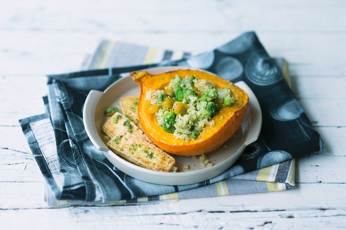 Hokkaido pumpkin filled with broccoli and couscous and fried smoked tofu
