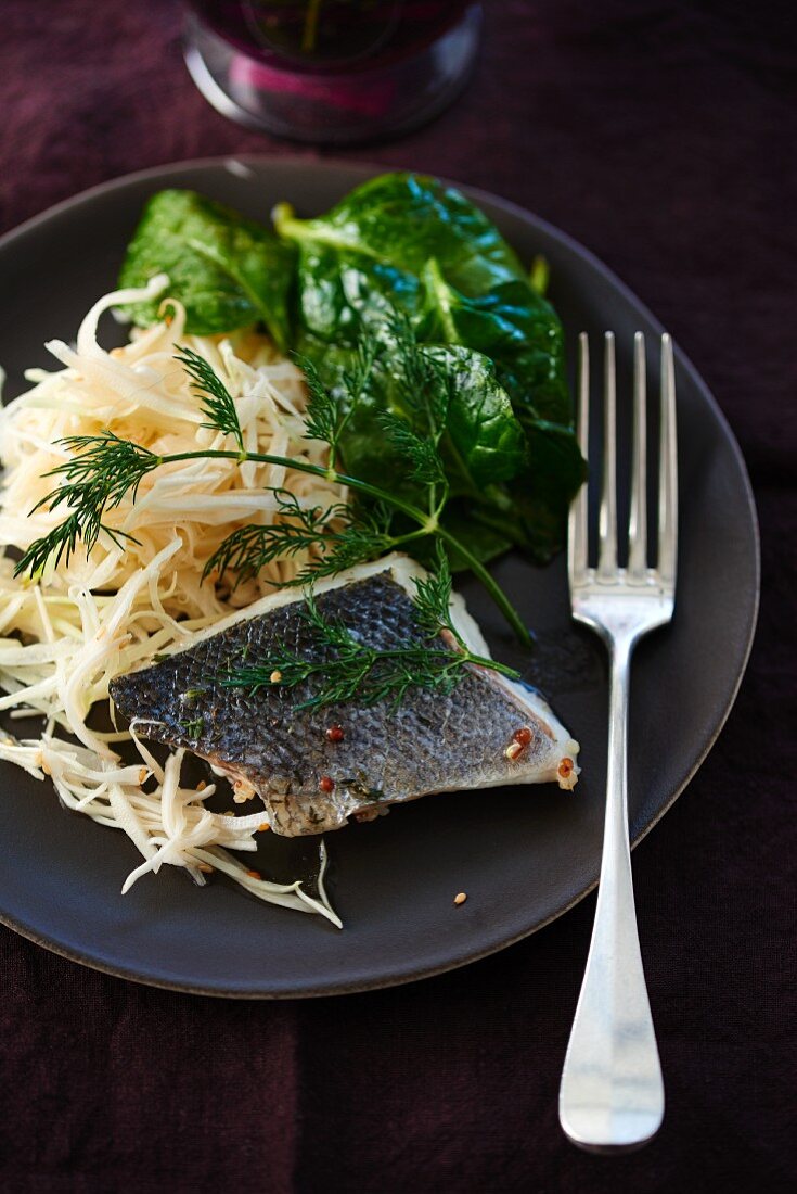 Branzini fillet with white cabbage and spinach