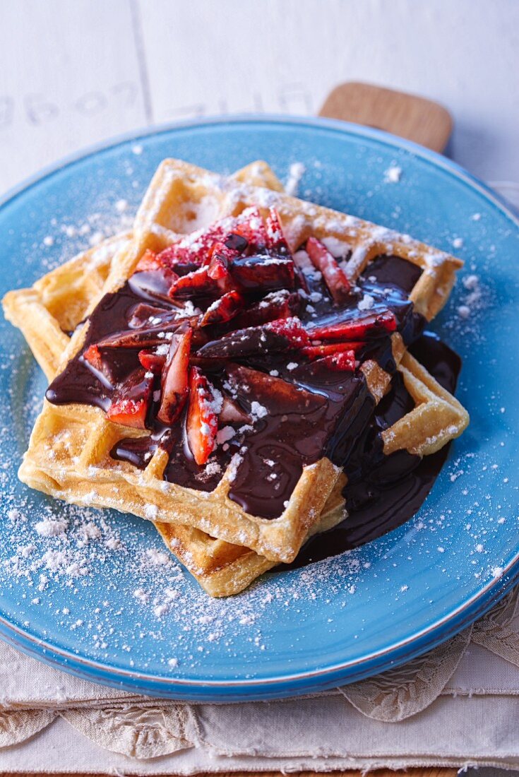 Waffles with chocolate sauce and strawberries