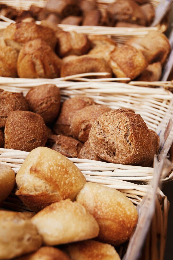 Various bread rolls in baskets in a bakery