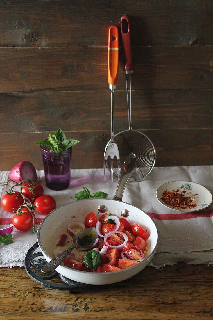 Fried tomatoes with onions and basil