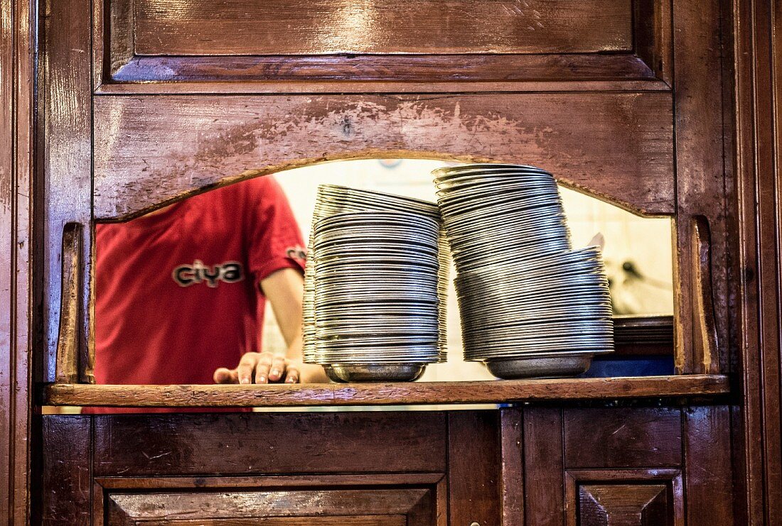 A stack of plate in a serving hatch