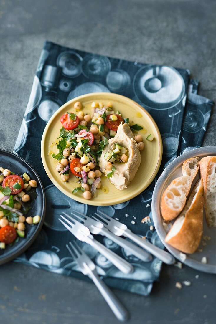 Chickpea salad with cherry tomatoes and parsley on hummus