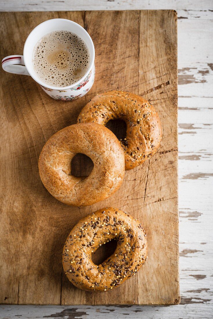Bagels and coffee on a chopping board