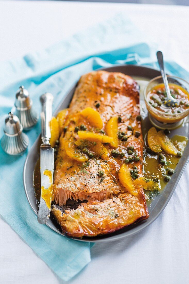 Smoked side of salmon with an orange and caper sauce and dill for Christmas dinner