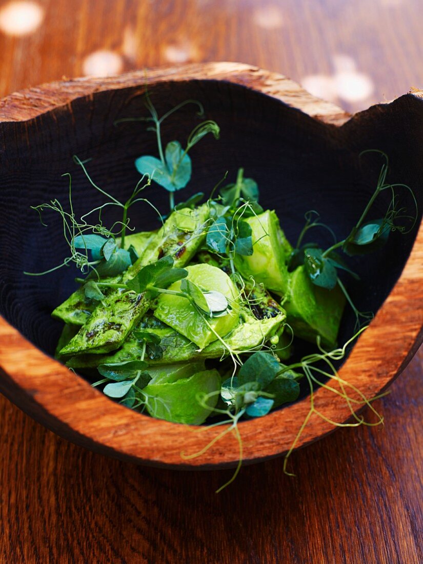 Kohlrabi baked in salt dough and grilled broad beans with shoots