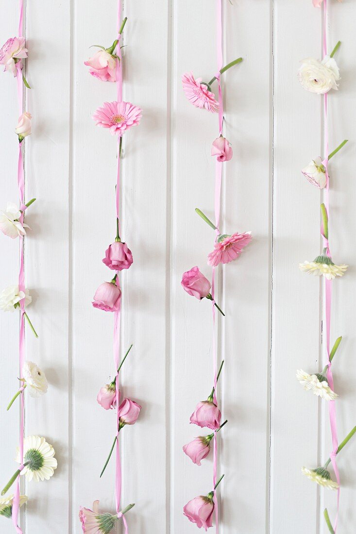 Romantic arrangement of pink and white flowers and ribbons for buffet