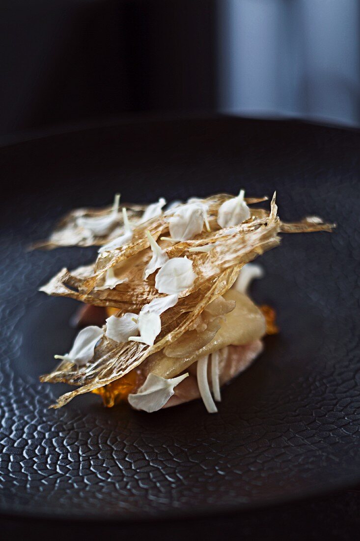 Quail poached in salt water with parsnip chips, egg and flower petals in 'Quay', Sydney