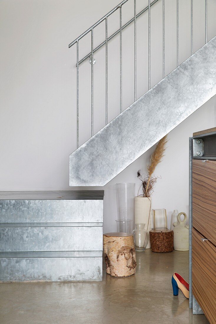 Detail of quarter-turn staircase made of galvanised sheet metal with stainless steel balustrade