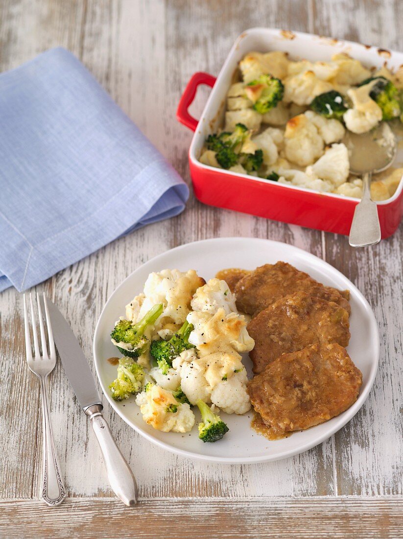 Cauliflower and broccoli bake with cream and mascarpone served with braised pork loin