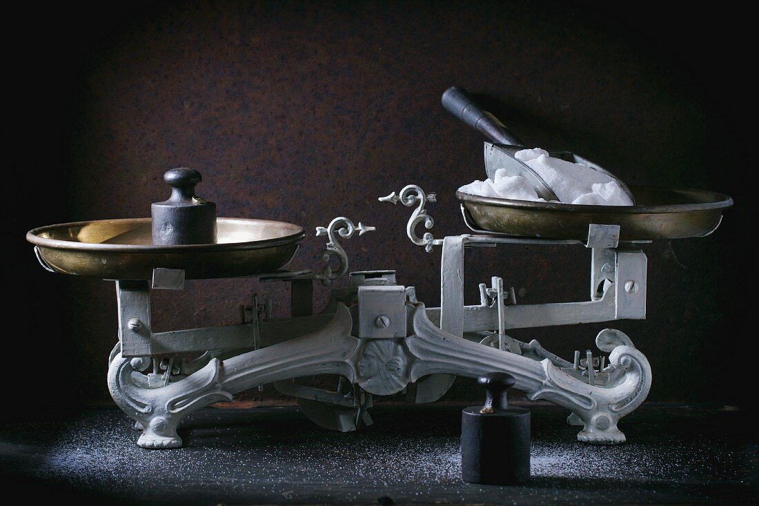 An antique pair of kitchen scales with weights