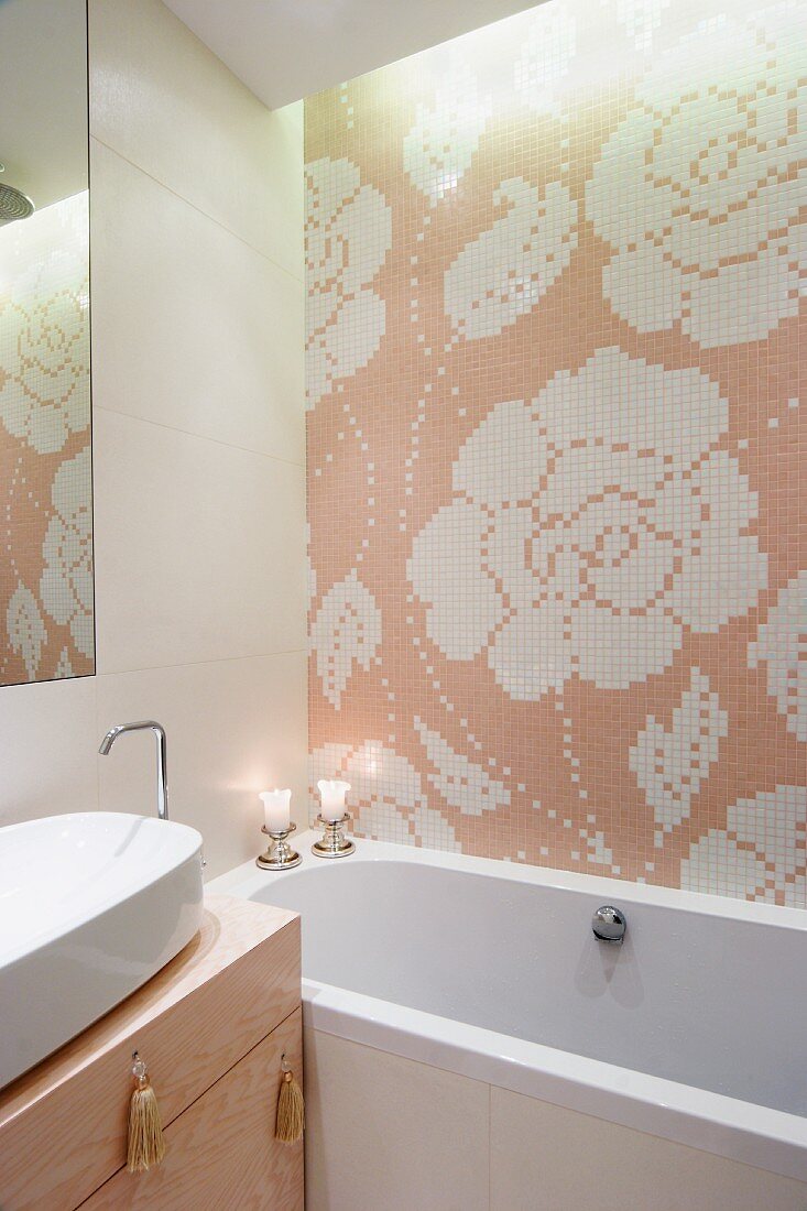 Floral tiled mosaic above bathtub and washstand with tassels on drawer handles