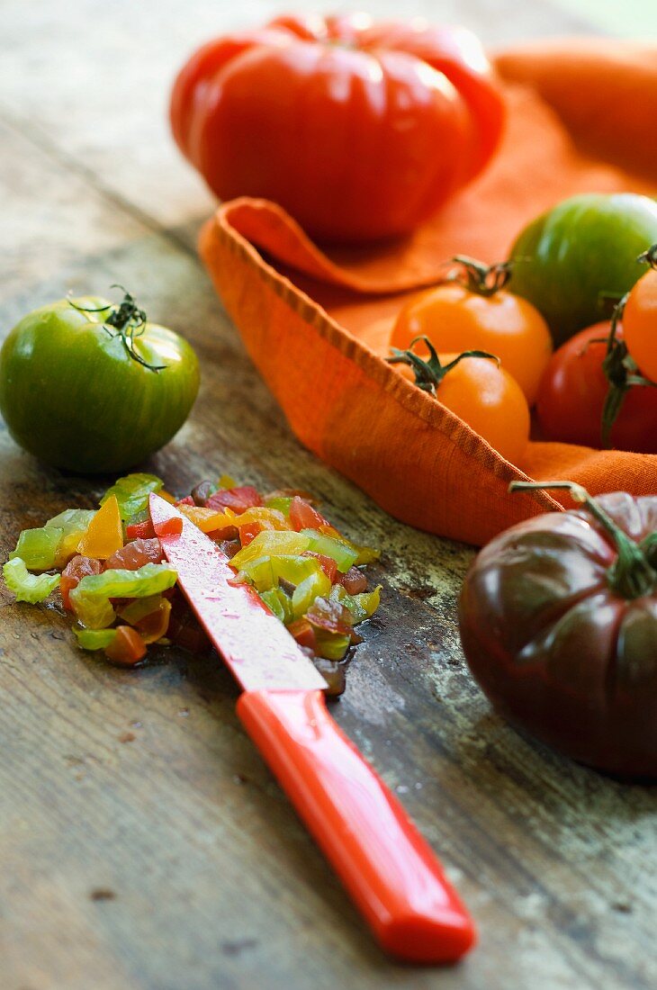 Various types of tomatoes with a knife