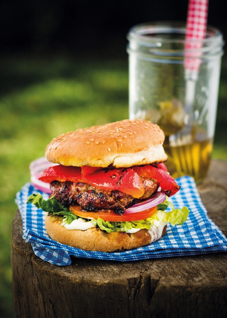 A jalapeño burger with grilled peppers, tomatoes and lettuce