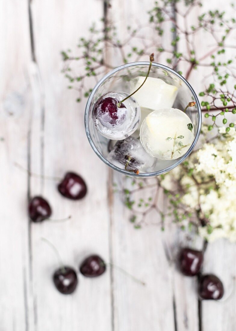 Ice cubes with cherries in a jar