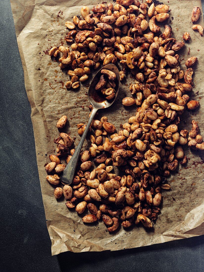 Spicy peanuts on a piece of baking paper (seen from above)
