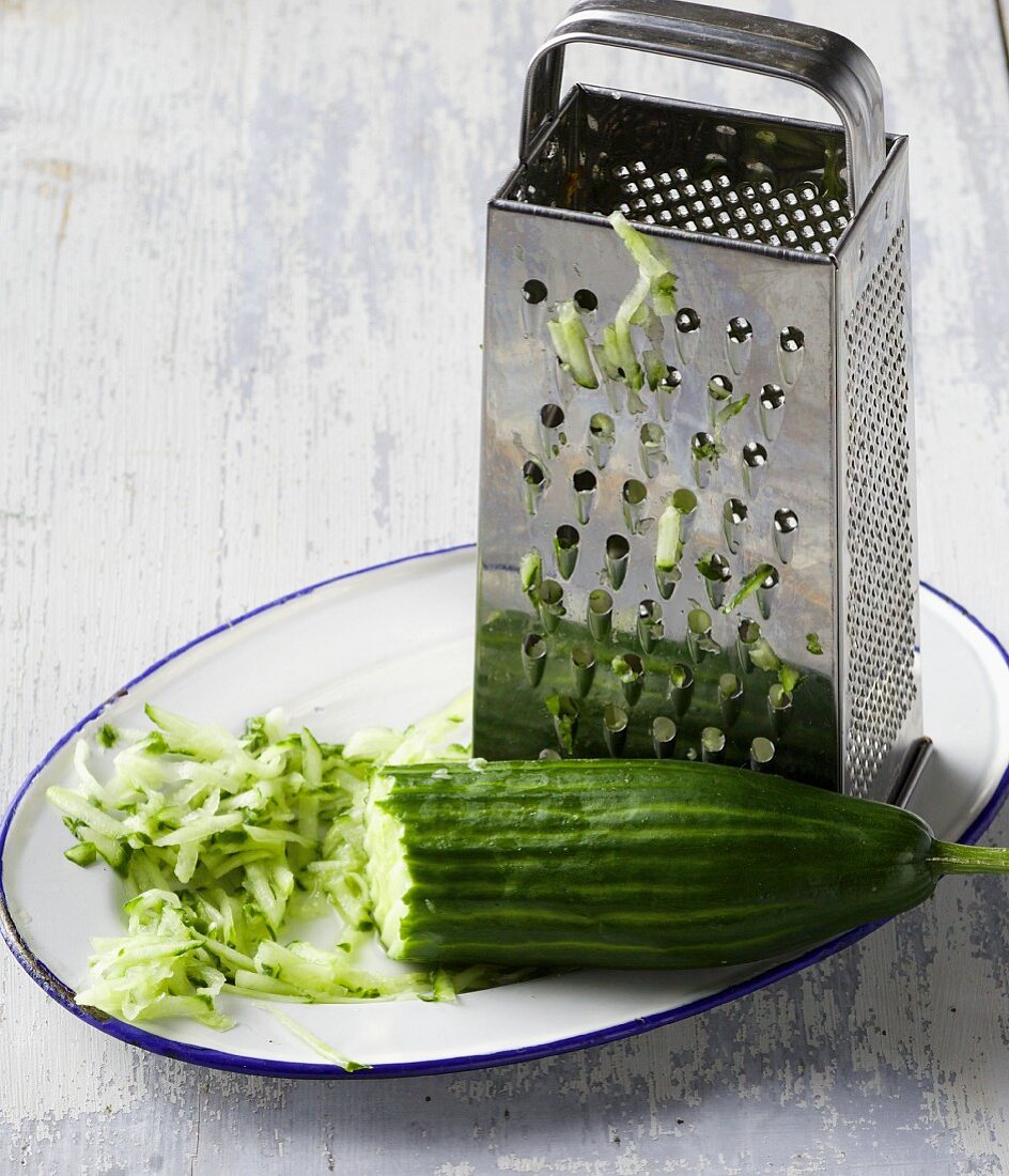A grater and grated cucumber