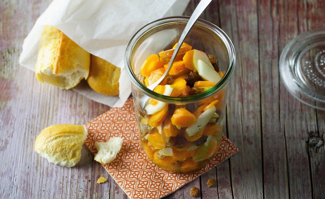 A glass of carrot and pear salad with raisins