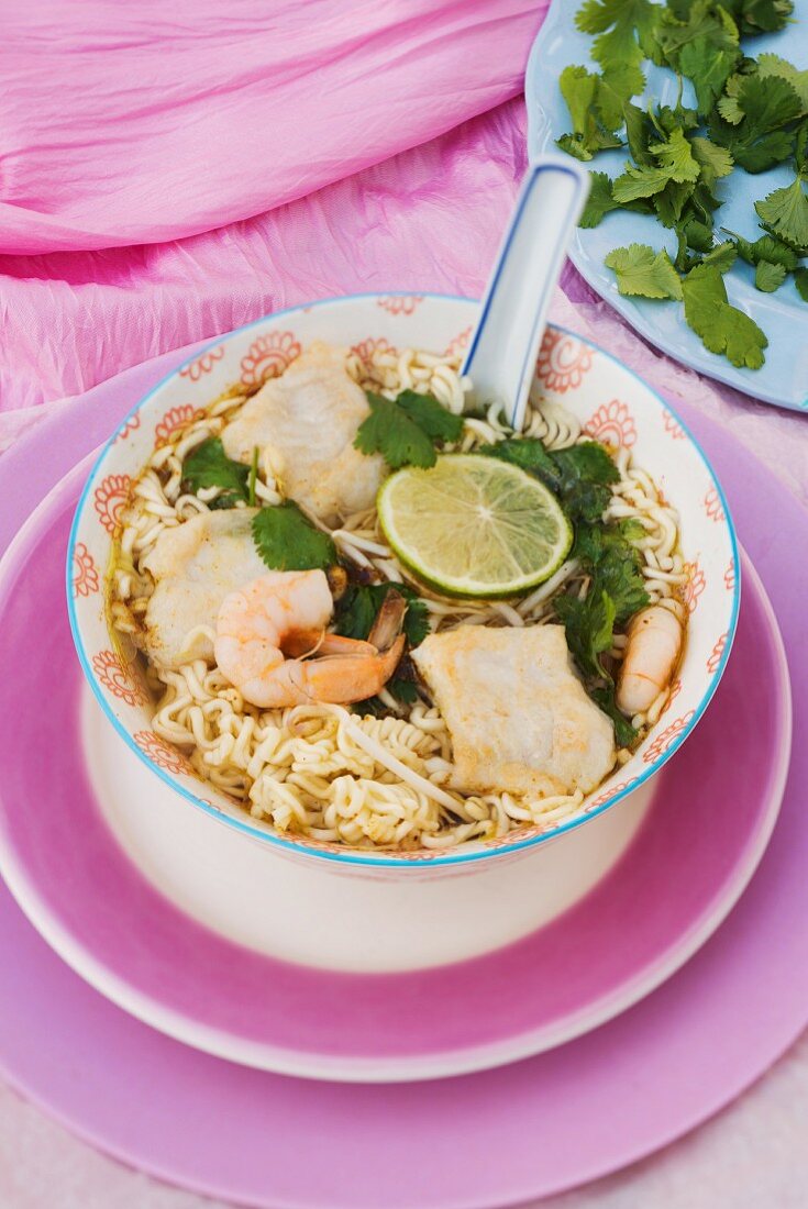 Oriental noodle soup with fish and prawns
