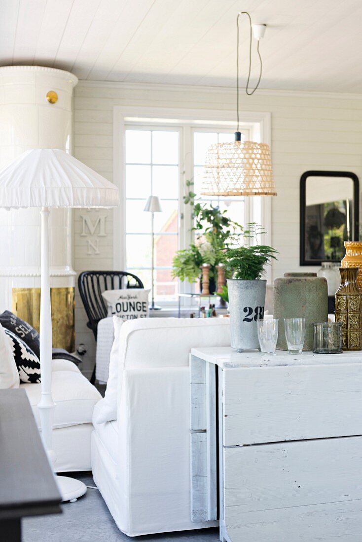 Flea-market finds on white wooden folding table against back of sofa