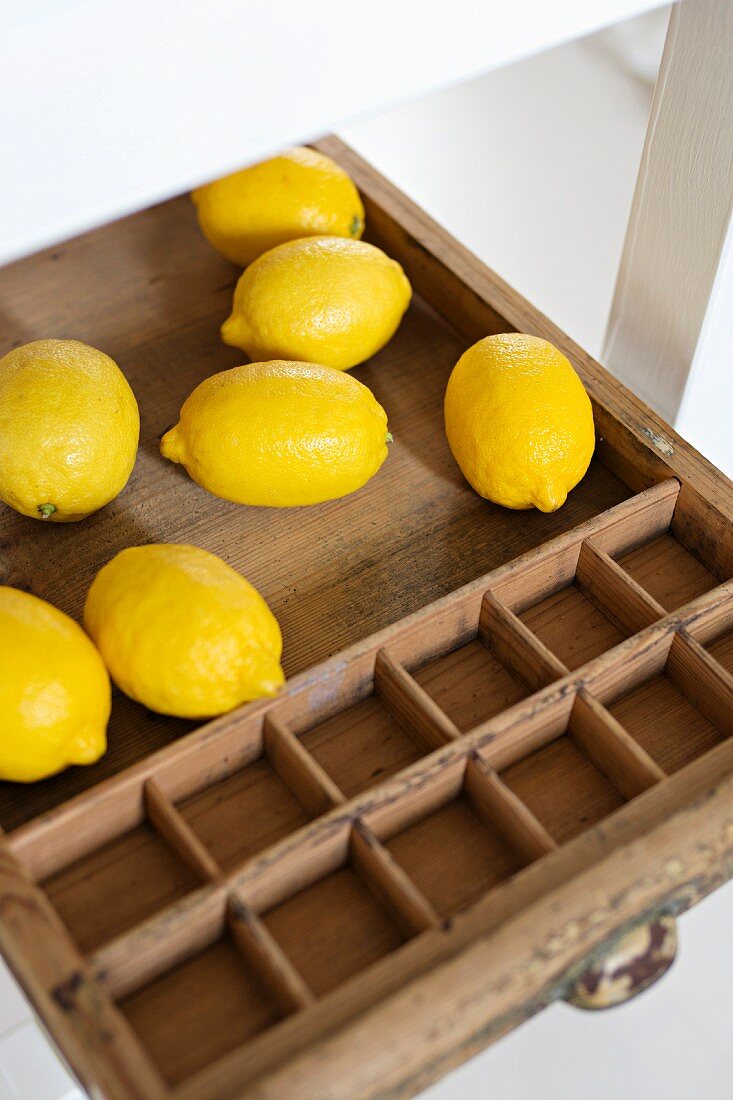 Lemons in vintage wooden tray