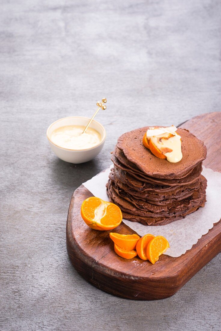 Chocolate pancakes with clementines and vanilla sauce