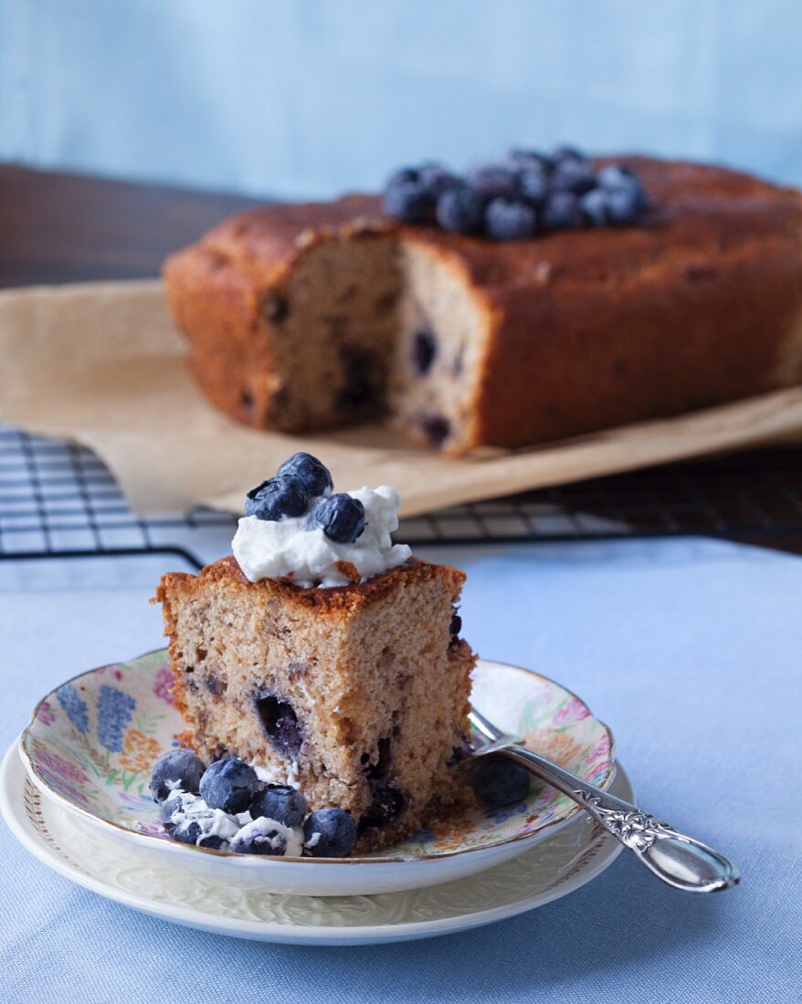 A coffee cake with blueberries and whipped cream